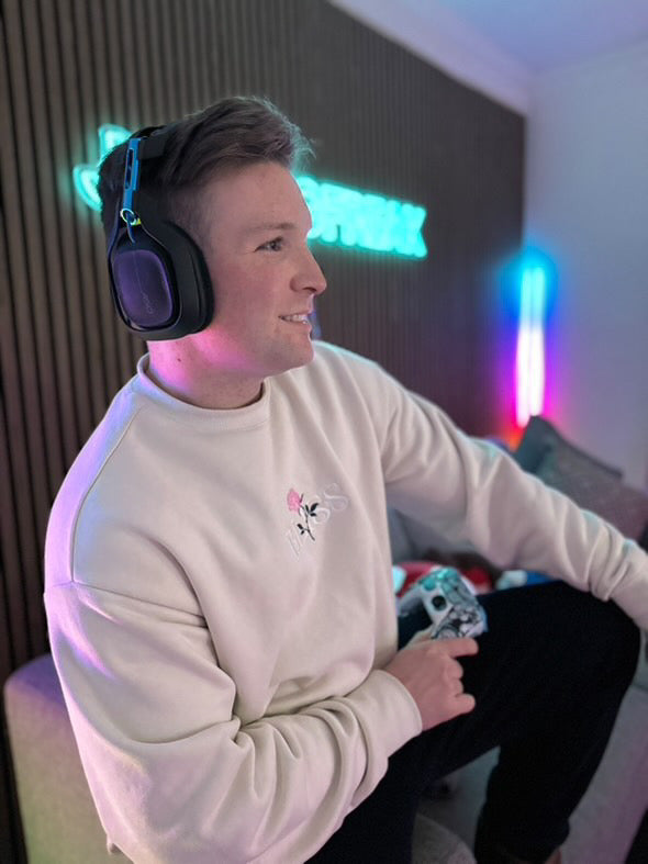 Custom neon sign in Melbourne gaming setup with glowing blue LED light backdrop.