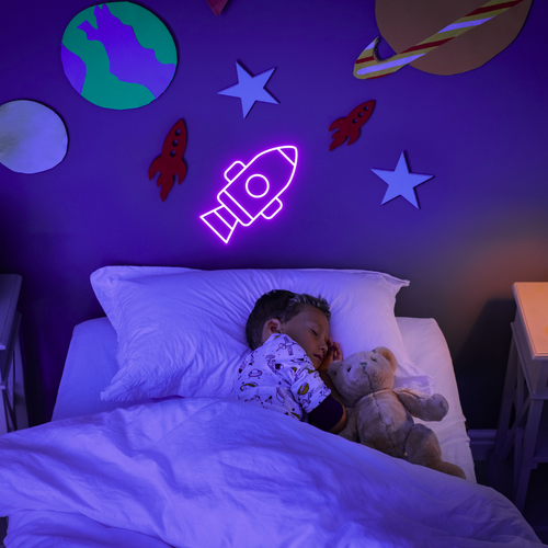 Purple rocket neon sign on the wall in a childrens bedroom