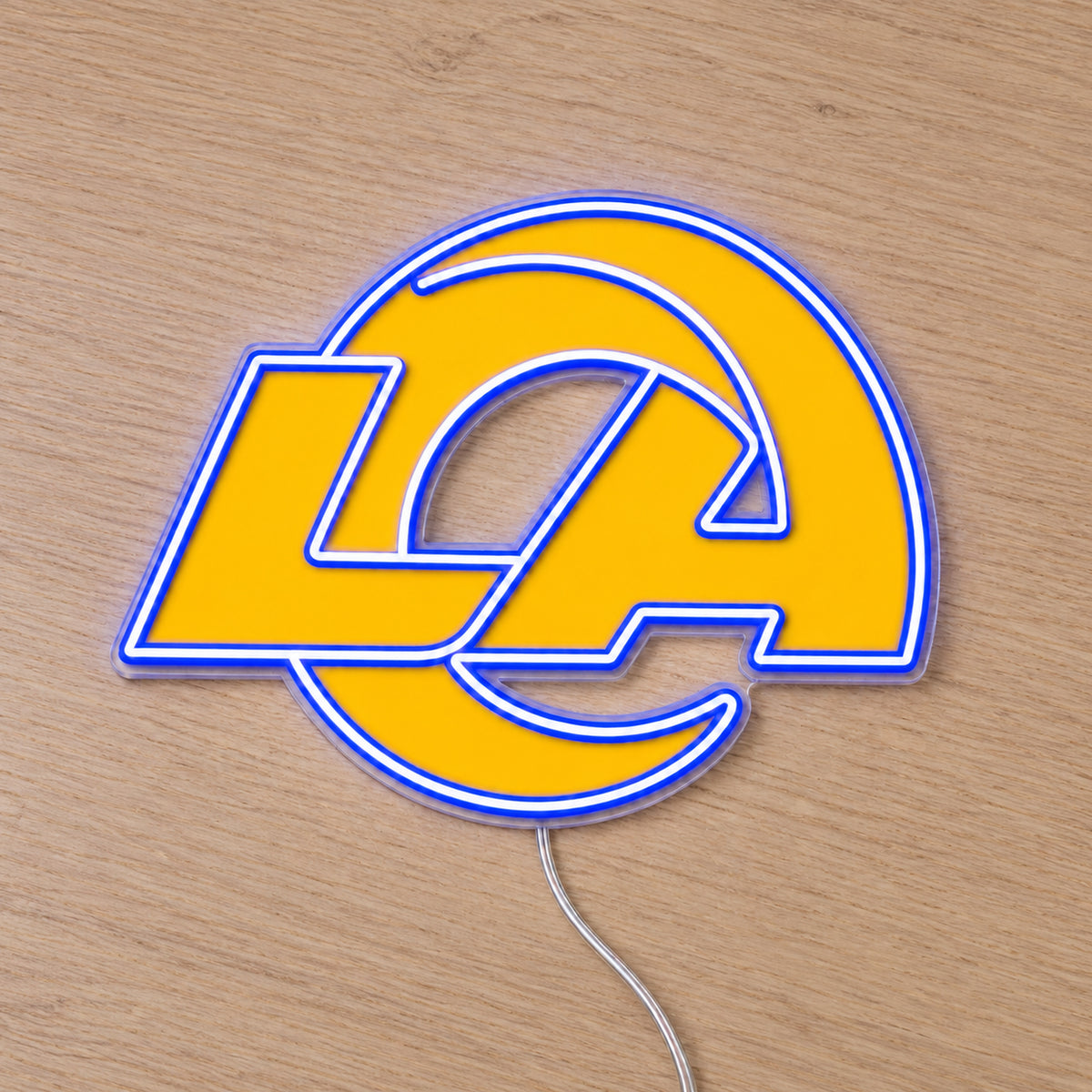 LA Rams LED Neon Sign, featuring illuminated team logo on a wooden surface.