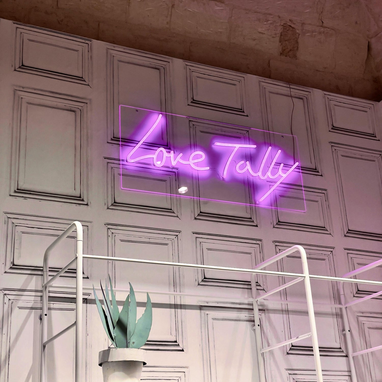 A picture of a purple neon sign for business called love tally in Melbourne
