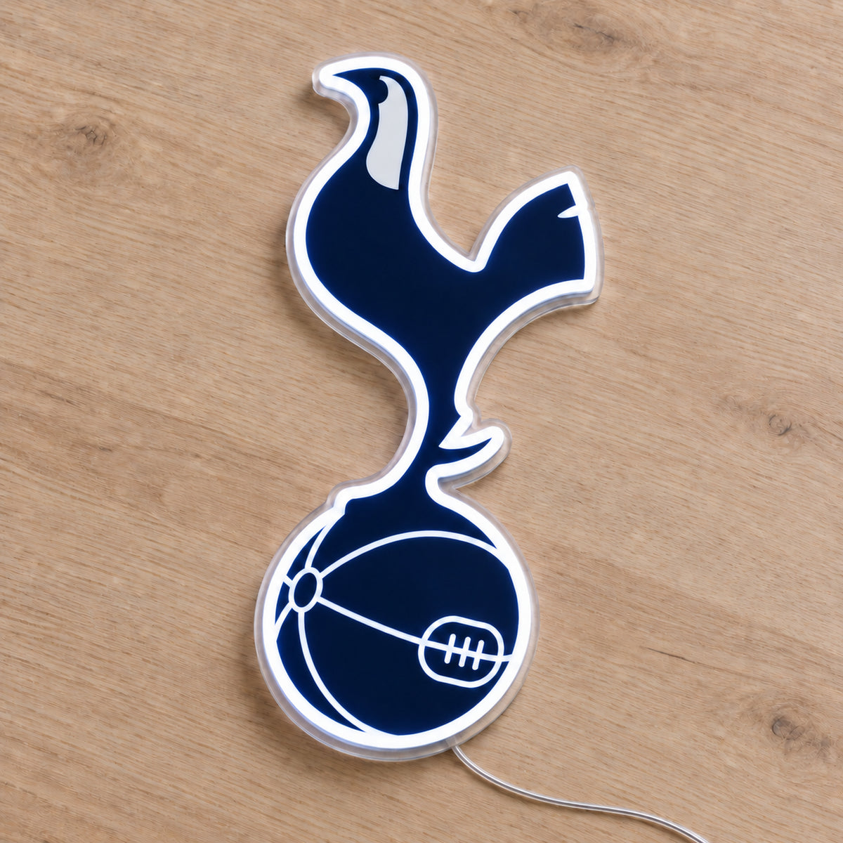 Tottenham LED Neon Sign, featuring team logo displayed on a wooden surface.