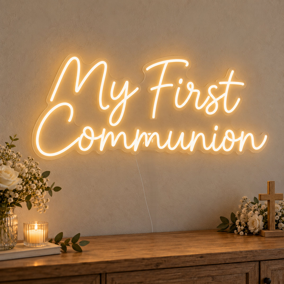 First Communion Neon Sign on clear cut-to-shape acrylic, illuminated on a wall in a styled celebration setting