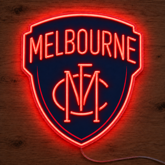 Melbourne Demons Neon Sign glowing bright red on a wooden surface in dimmed room lighting