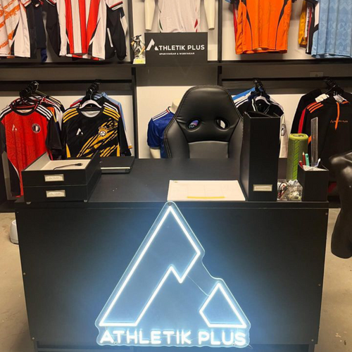 White custom neon logo sign displayed inside a Melbourne clothing store.