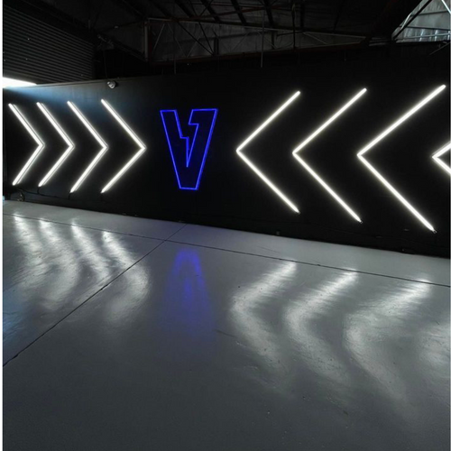 Dark blue custom neon logo sign for Voltaic Auto Electricians in Perth workshop.