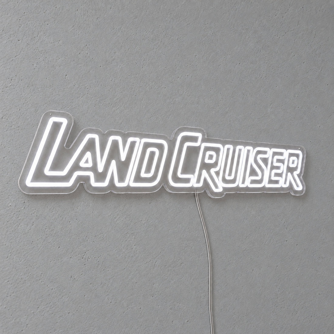 Toyota Land Cruiser LED Neon Sign in white, featuring Land Cruiser lettering on a grey wall.