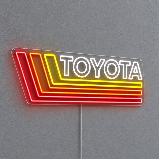 Toyota Retro Land Cruiser LED Neon Sign in white, red and yellow, featuring Toyota lettering with retro stripes on a grey wall.