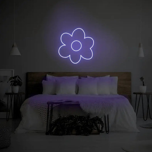 Flower LED Neon Light Sign in purple, featuring flower outline illuminated above a bed.