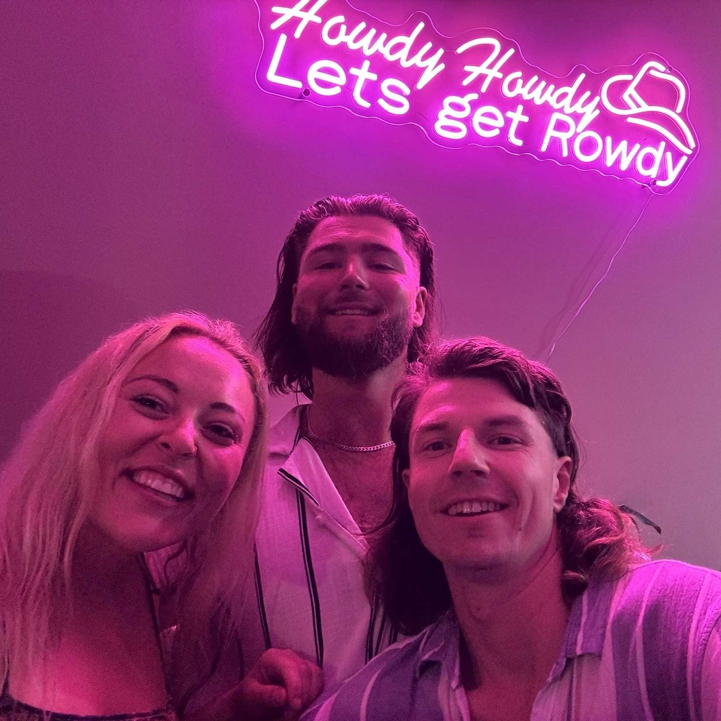 Pink and Purple neon sign saying "Howdy Howdy Lets get rowdy" for Home Bar in Australia