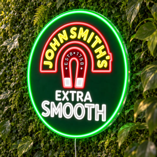 John Smith's LED Neon Sign, featuring beer-brand logo displayed on a green foliage wall.