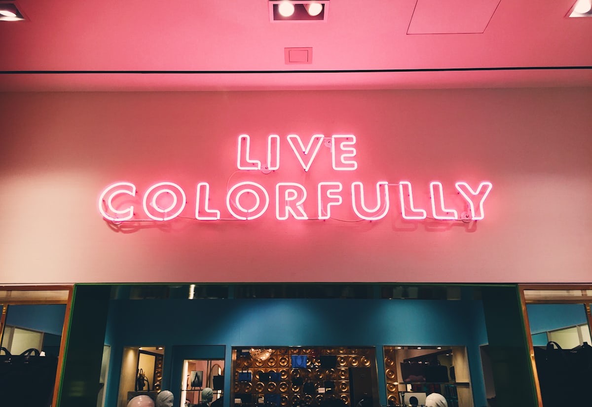 LIVE COLOURFULLY pink neon sign in melbourne restaurant