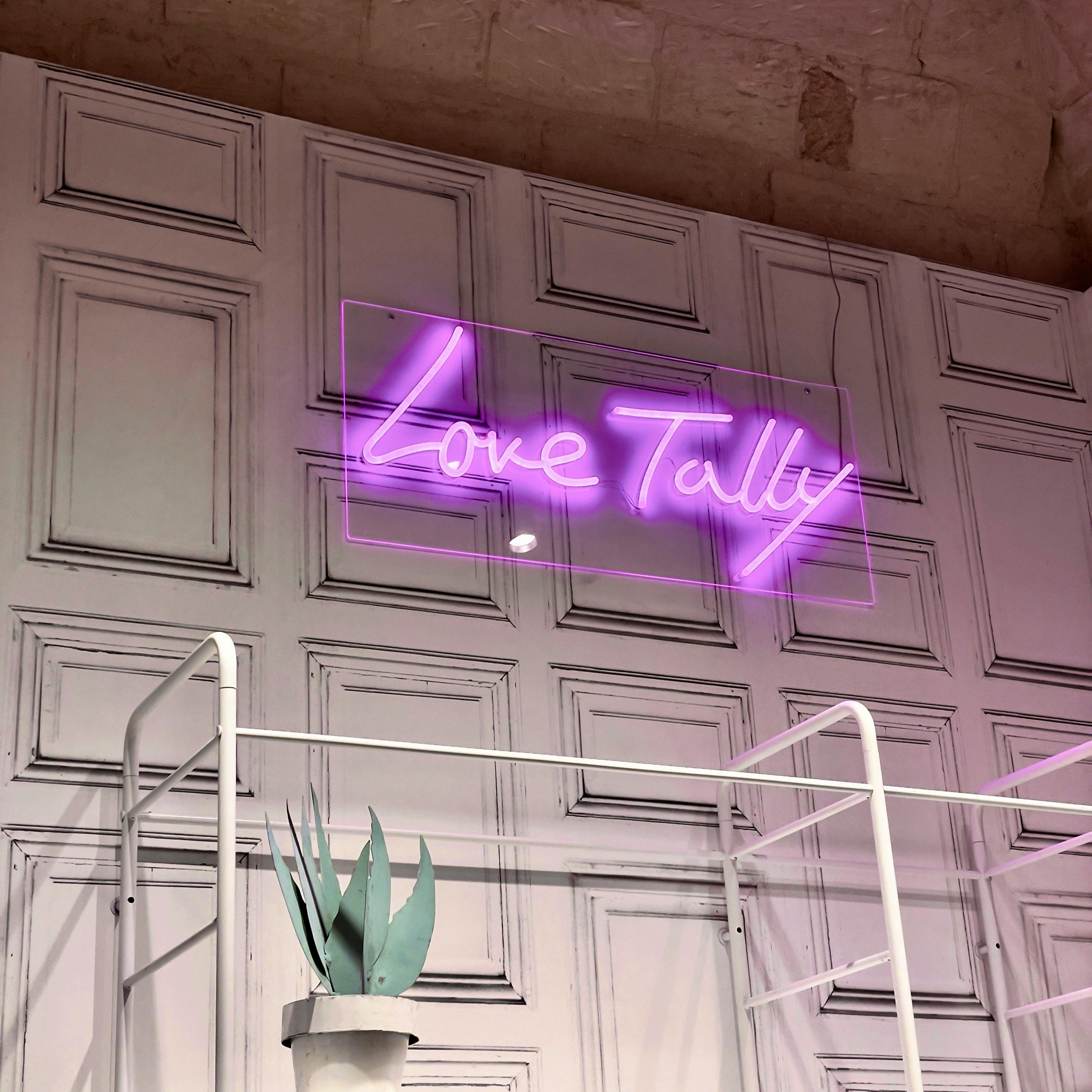  A picture of a purple neon sign for business called love tally in Melbourne