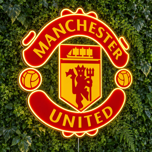 Manchester United LED Neon Sign, featuring team logo displayed on a green foliage wall.