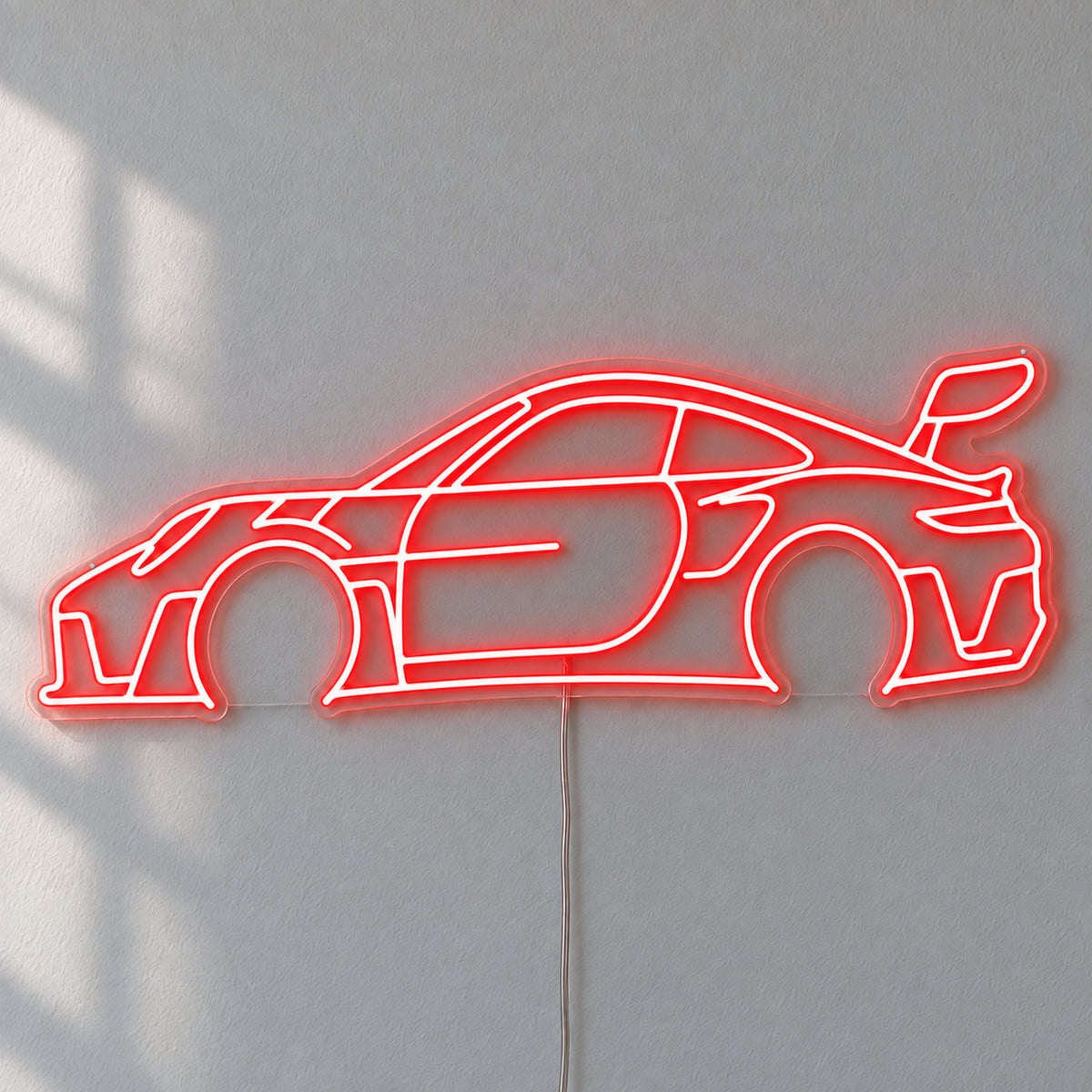 Porsche 911 LED Neon Sign in red, featuring a Porsche 911 car outline on a grey wall.