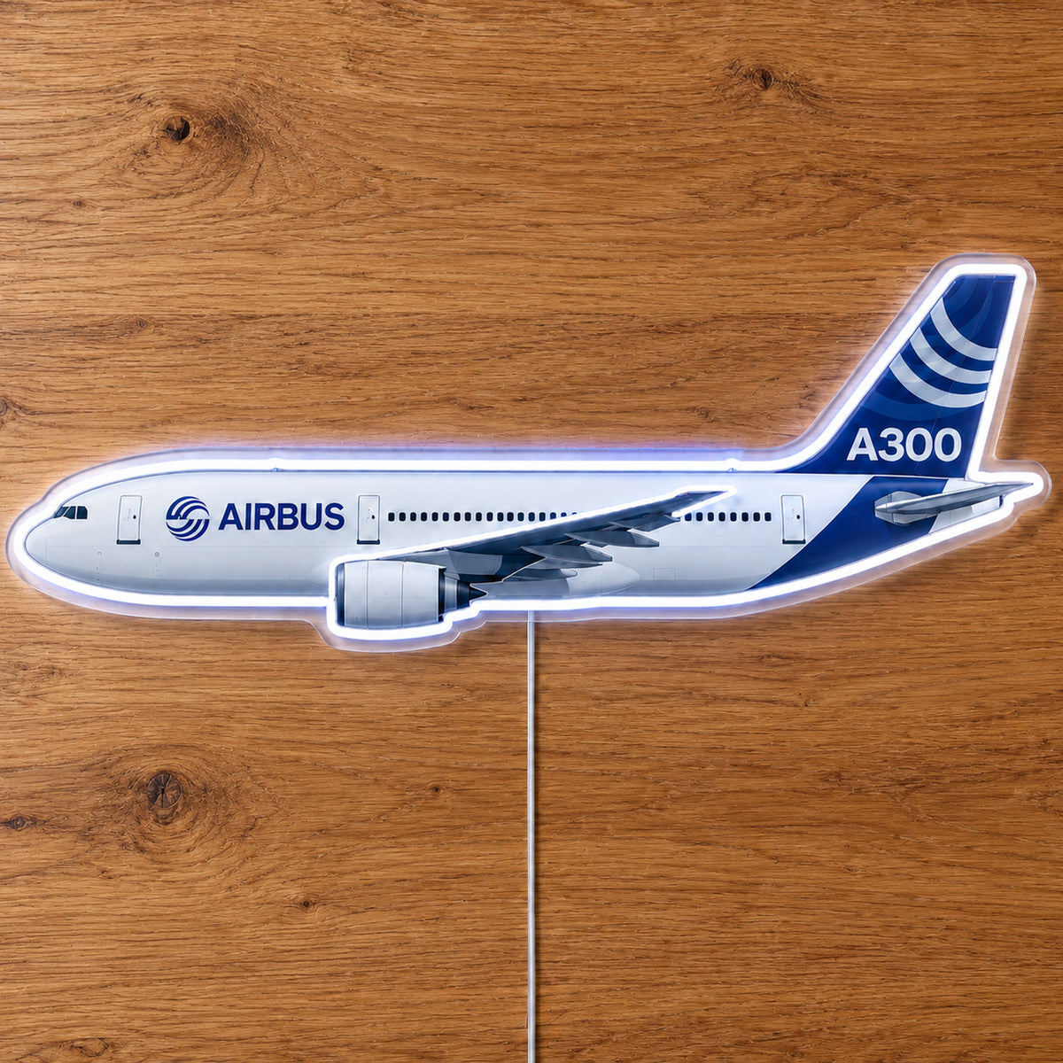 Airbus A300 Neon Sign with printed aircraft details and an illuminated LED outline on clear acrylic, shown on a wooden surface