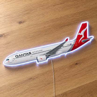 Airbus A330-300 Qantas Neon Sign with printed aircraft details and an illuminated LED outline on clear acrylic, shown on a wooden surface, registration VH-QPJ
