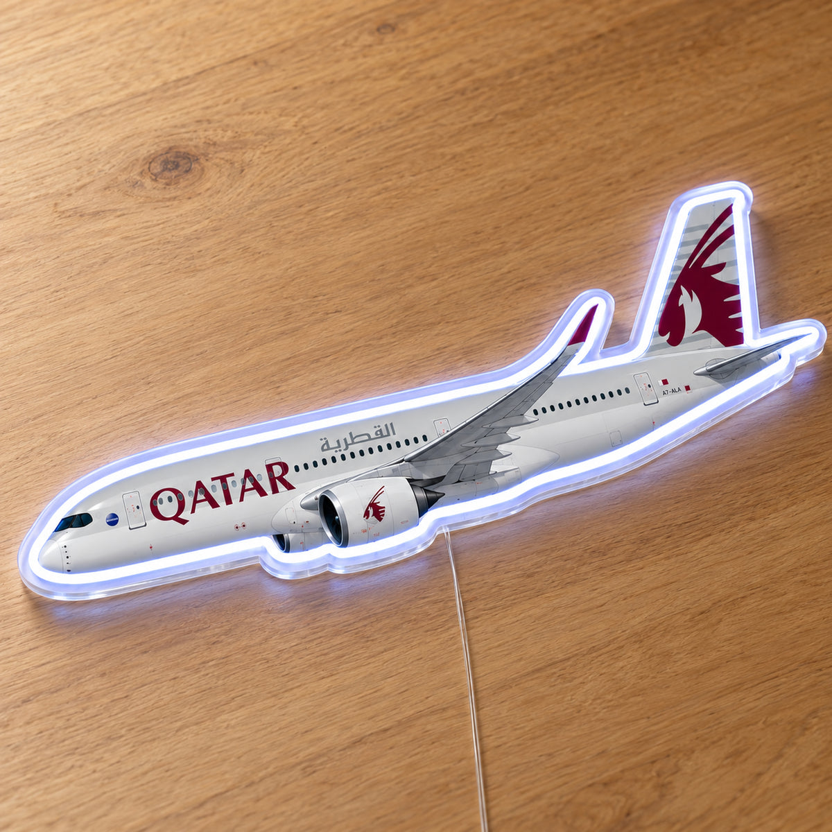 Airbus A350-900 Qatar Airways Neon Sign with printed aircraft details and an illuminated LED outline on clear acrylic, shown on a wooden surface, registration A7-ALA