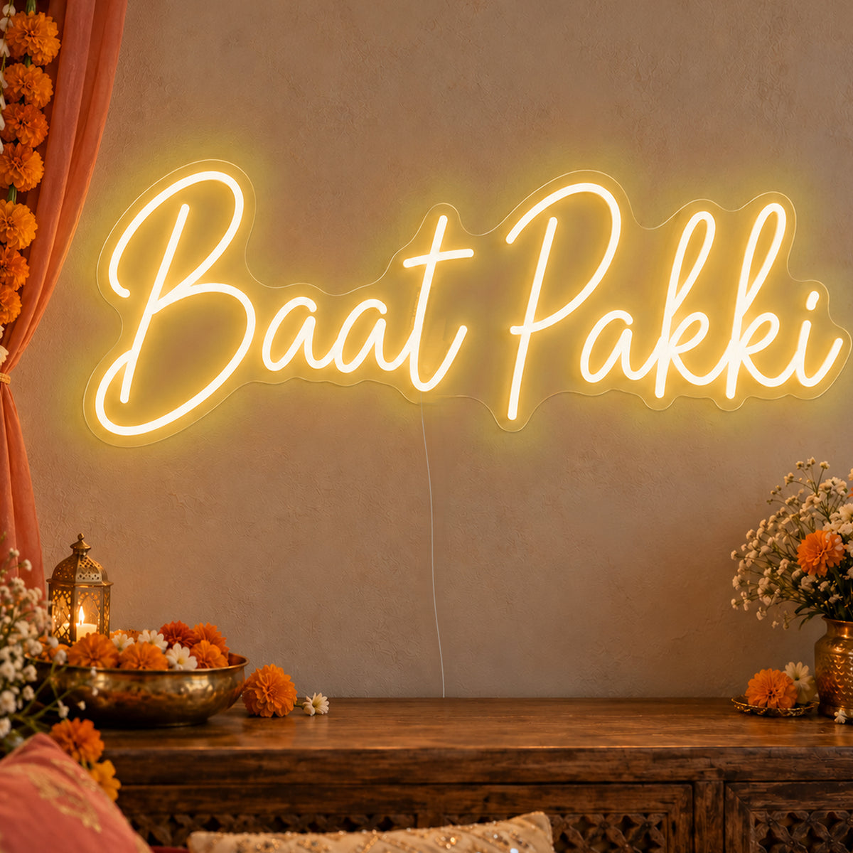 Baat Pakki Neon Sign in gold LED neon on clear acrylic, angled view