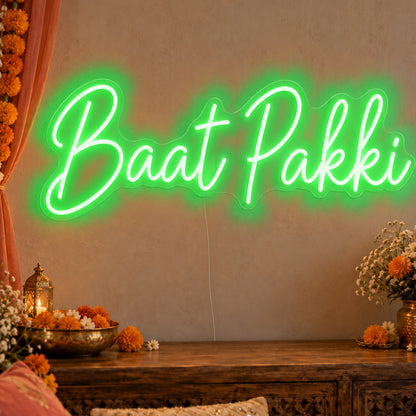 Baat Pakki Neon Sign in green LED neon on clear acrylic, angled view
