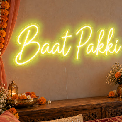 Baat Pakki Neon Sign in yellow LED neon on clear acrylic, angled view