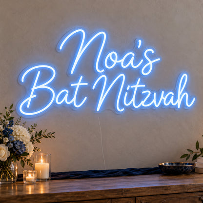 Personalised Bat Mitzvah Neon Sign on clear cut-to-shape acrylic, illuminated on a wall in a styled celebration setting; sample personalised wording shown