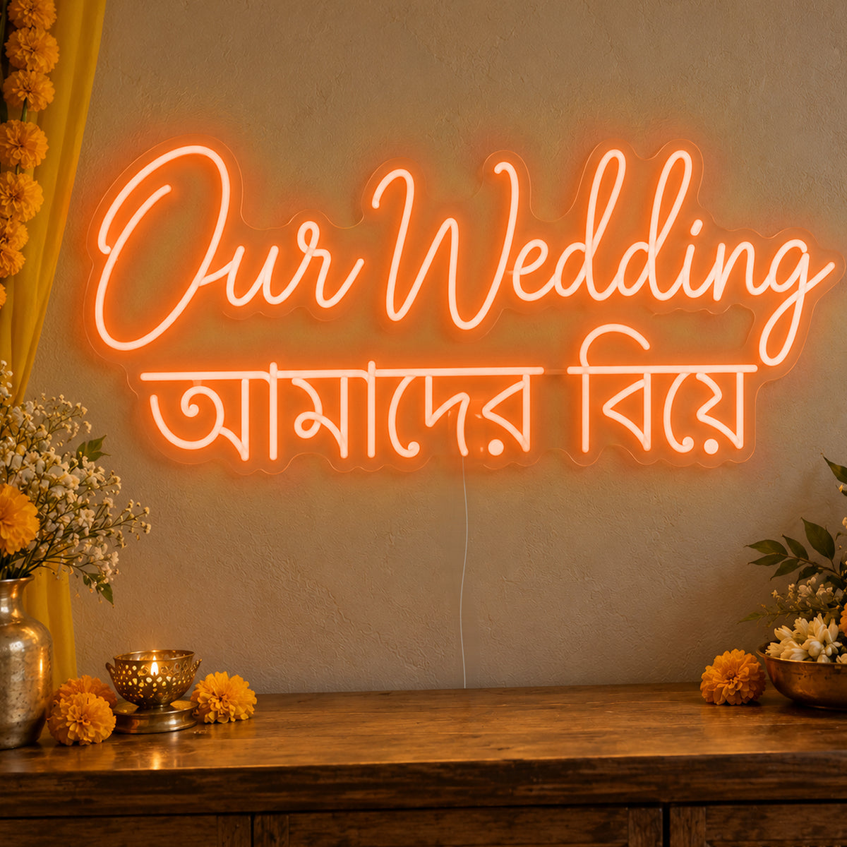 Our Wedding English & Bengali Neon Sign in orange LED neon on clear acrylic, angled view