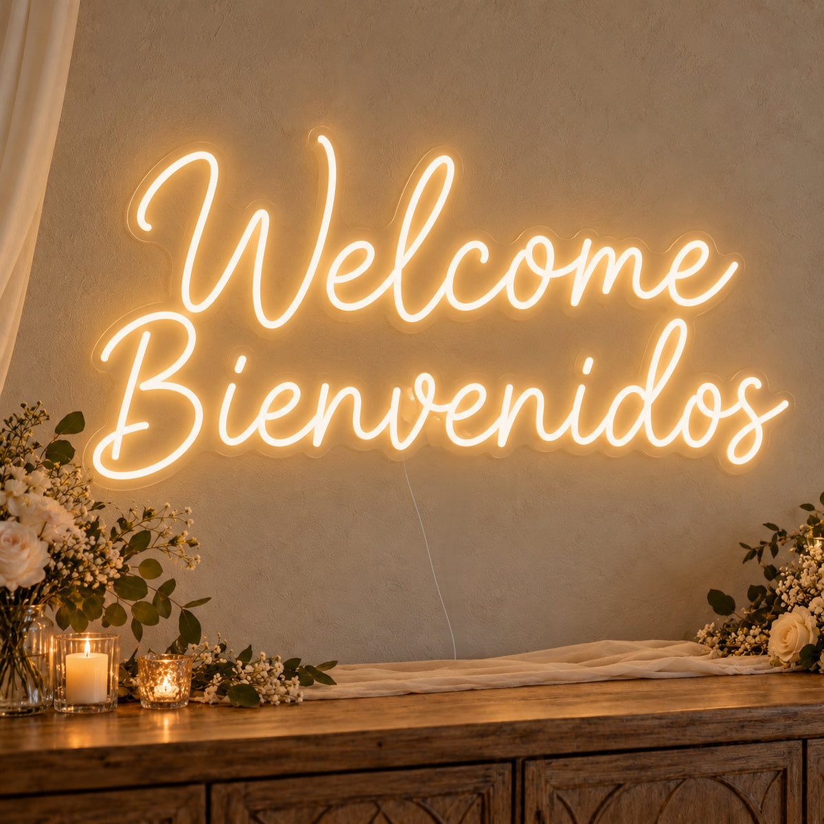 Welcome English & Spanish Neon Sign on clear cut-to-shape acrylic, illuminated on a wall in a styled celebration setting
