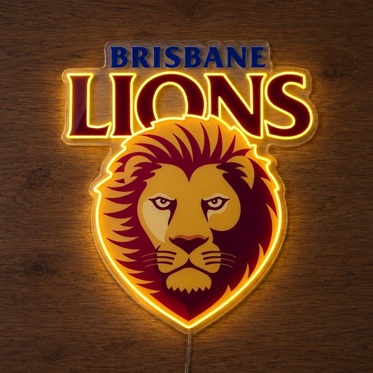 Brisbane Lions neon sign glowing brightly on a wooden surface in dim lighting