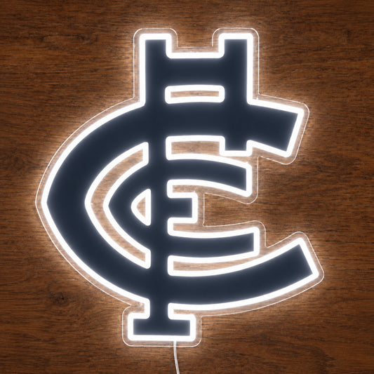Carlton Blues neon sign glowing brightly on a wooden surface in dim lighting