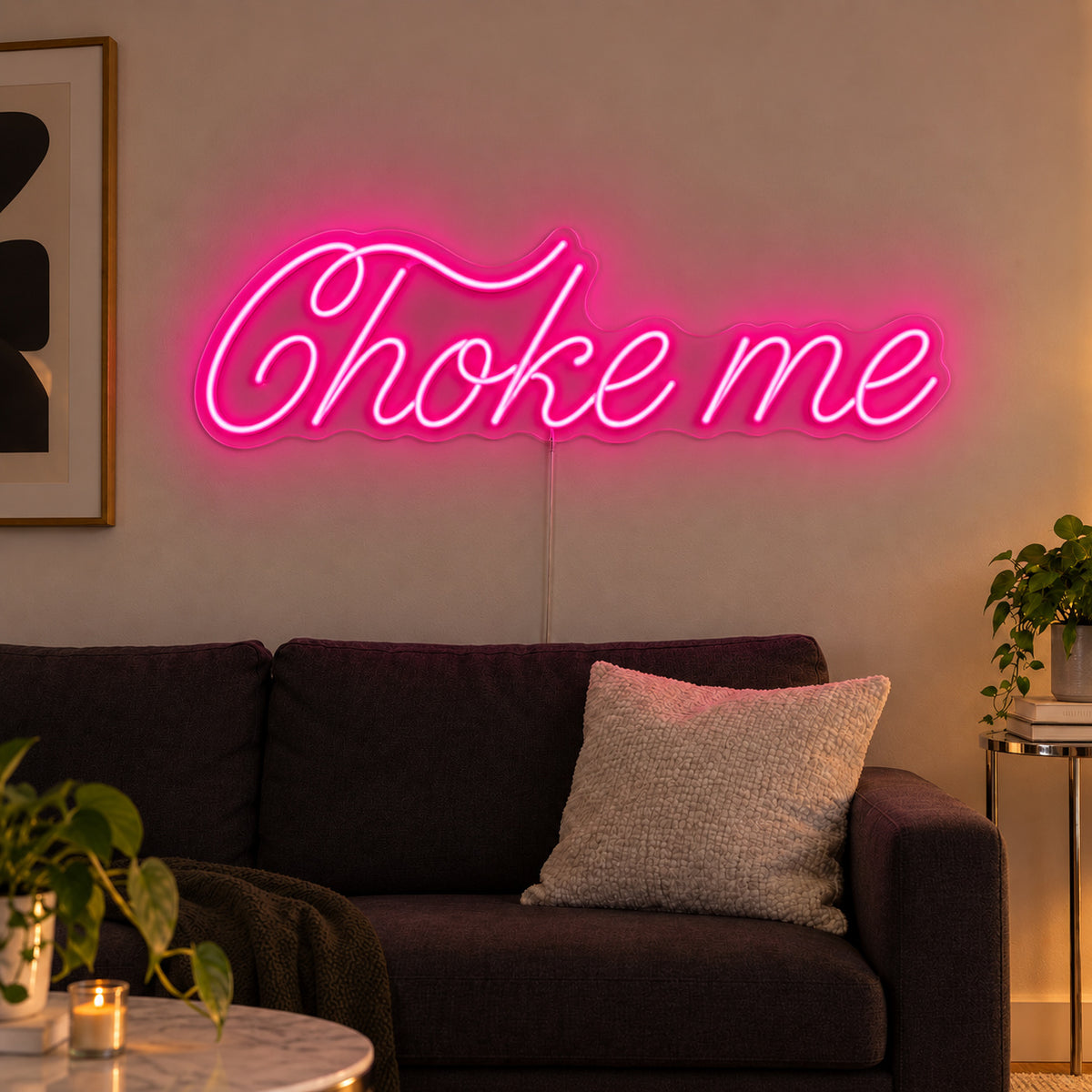 Rose Red version of the Choke Me Neon Sign, shown above a charcoal sofa.