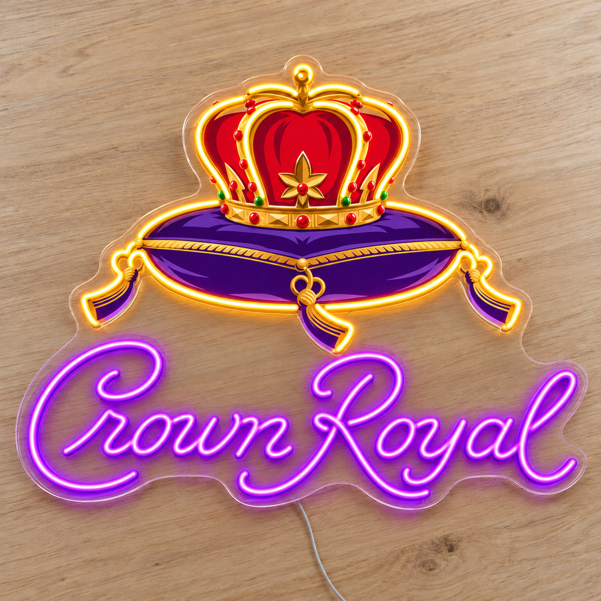 Crown Royal LED neon sign on a light wooden surface, front view