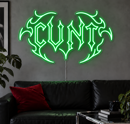 Cunt Neon Sign in Green LED neon with double outlined C, displayed above a black leather sofa.