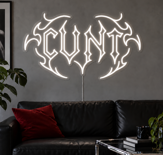 Cunt Neon Sign in White LED neon with double outlined C, displayed above a black leather sofa.