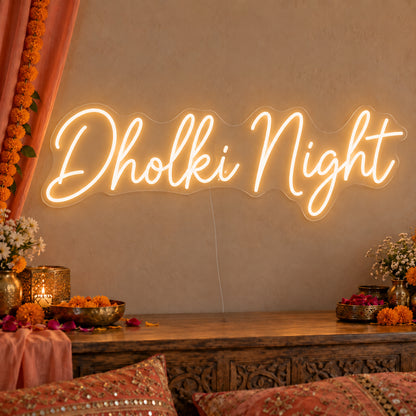 Dholki Night Neon Sign on clear cut-to-shape acrylic, illuminated on a wall in a styled celebration setting