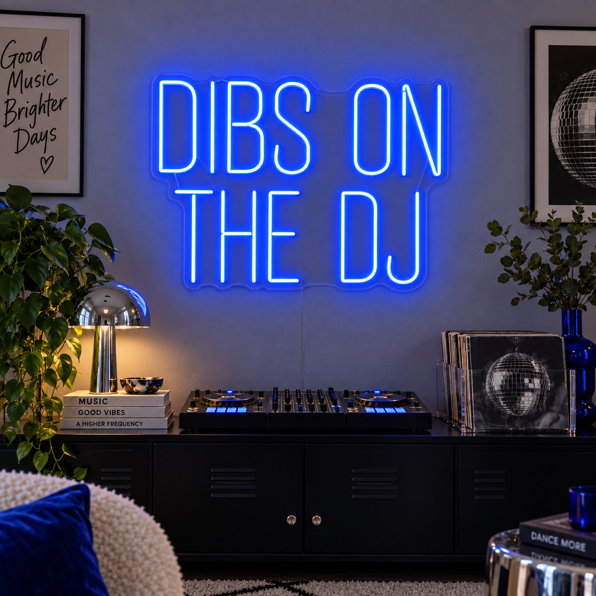 Dibs On The DJ Neon Sign glowing blue above a home DJ setup.