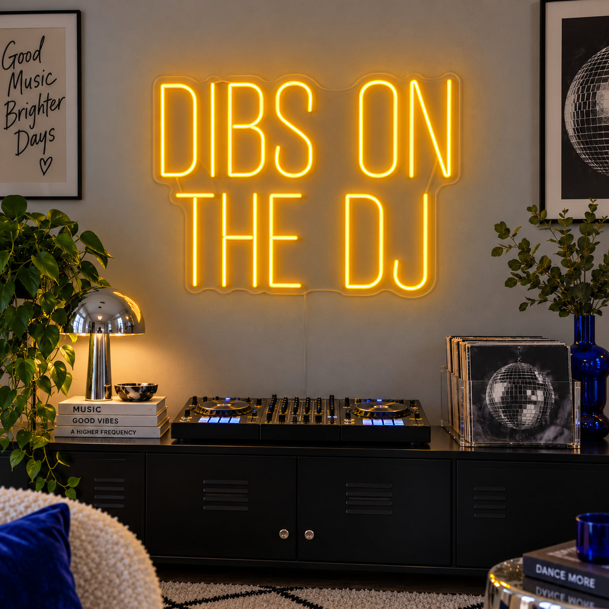 Dibs On The DJ Neon Sign glowing gold above a home DJ setup.