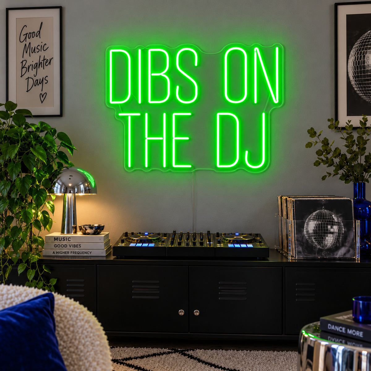 Dibs On The DJ Neon Sign with green lighting, displayed above a home DJ setup.