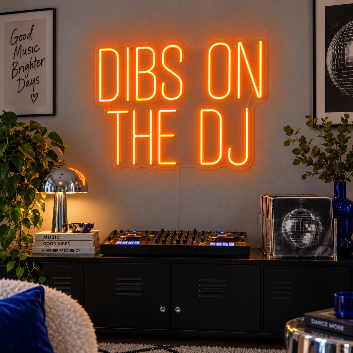 Orange version of the Dibs On The DJ Neon Sign, shown above a home DJ setup.
