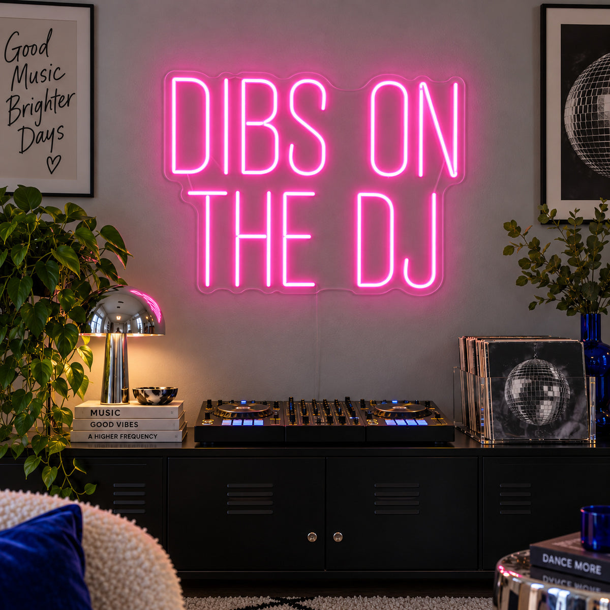 Dibs On The DJ Neon Sign glowing pink above a home DJ setup.