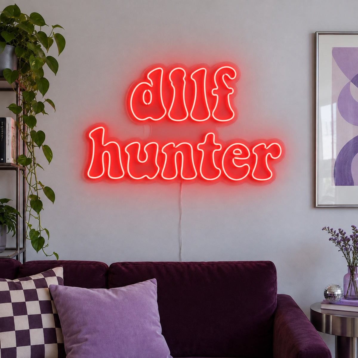 DILF Hunter Neon Sign with red lighting, displayed above a sofa with purple cushions.