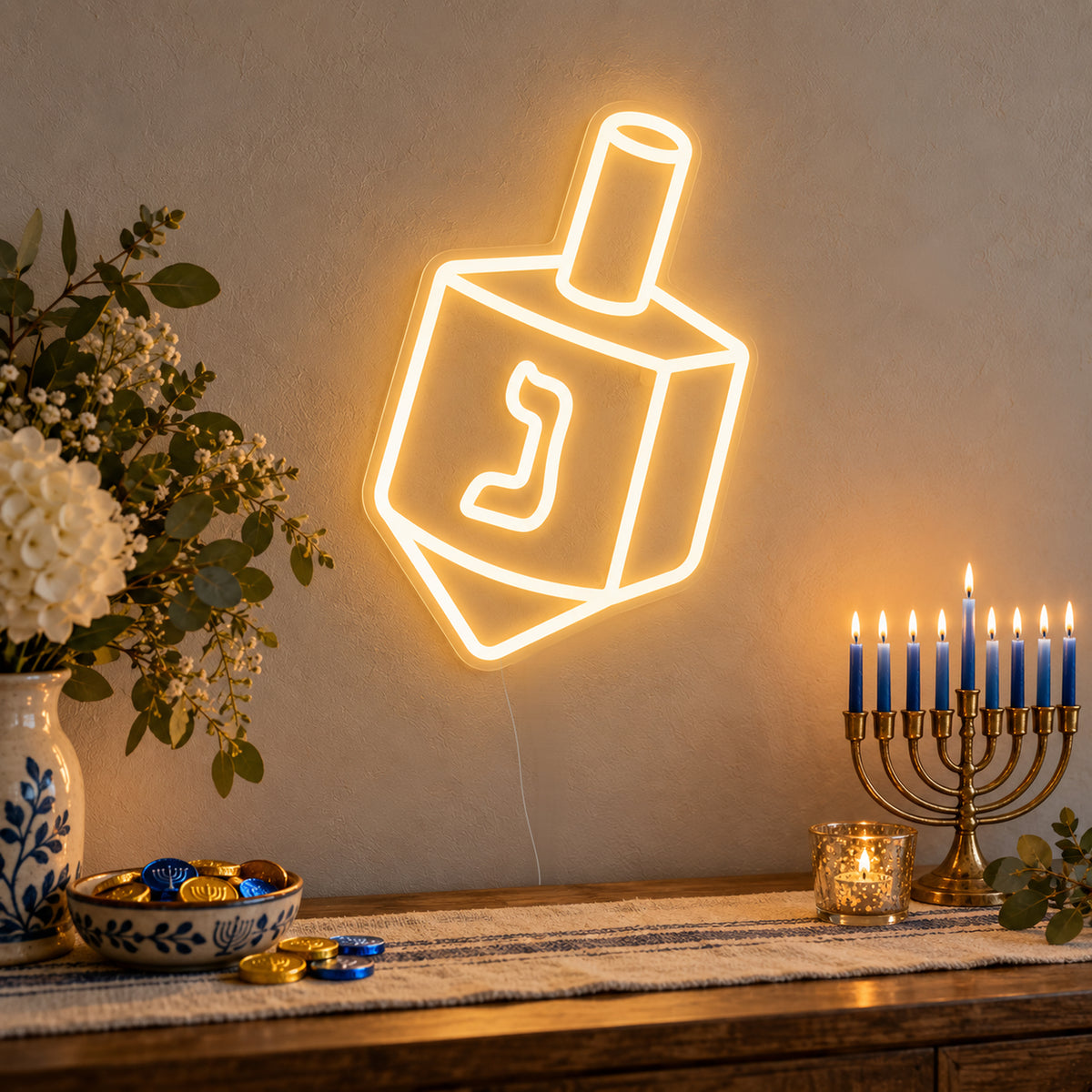 Dreidel Neon Sign on clear cut-to-shape acrylic, illuminated on a wall in a styled celebration setting