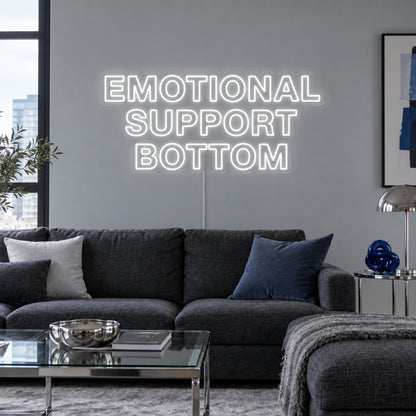 Emotional Support Bottom Neon Sign, RGB colour-changing option shown in white above a charcoal sofa.