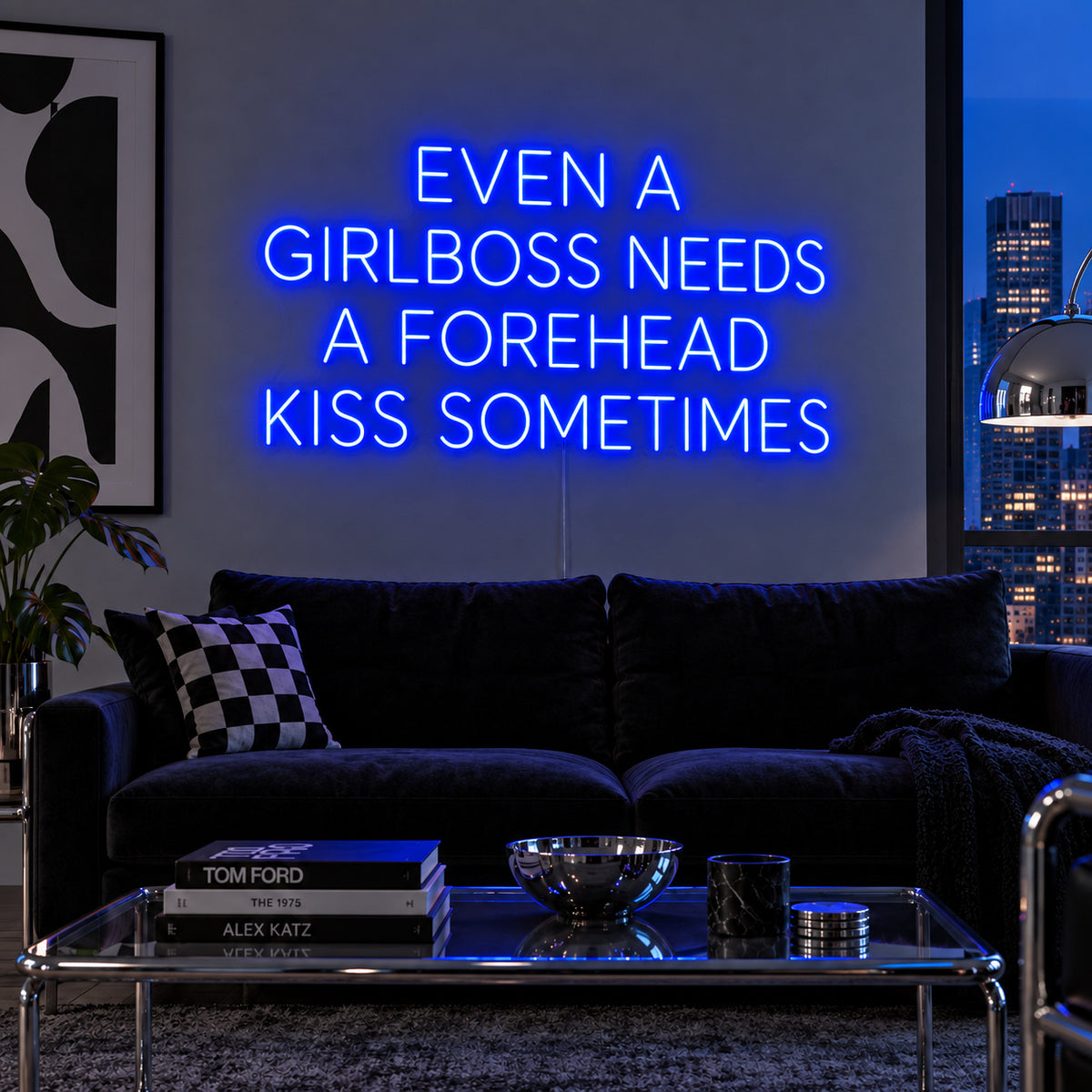Even A Girlboss Needs A Forehead Kiss Sometimes Neon Sign glowing blue above a dark sofa and mirrored coffee table.