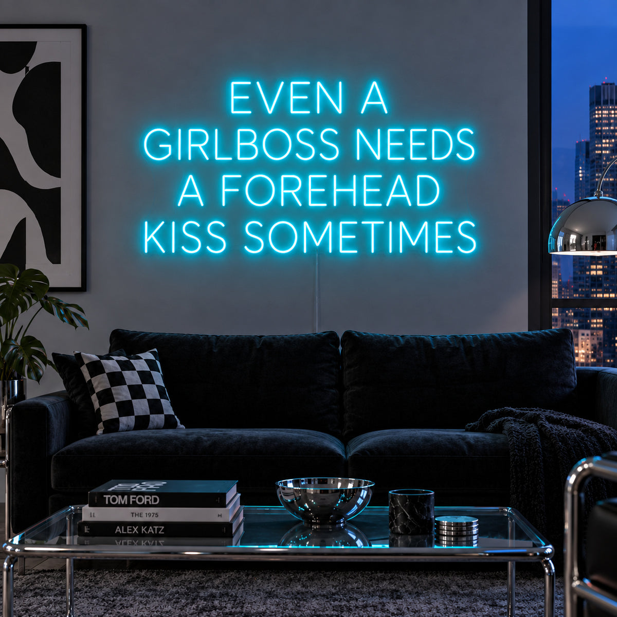 Ice Blue version of the Even A Girlboss Needs A Forehead Kiss Sometimes Neon Sign, shown above a dark sofa and mirrored coffee table.