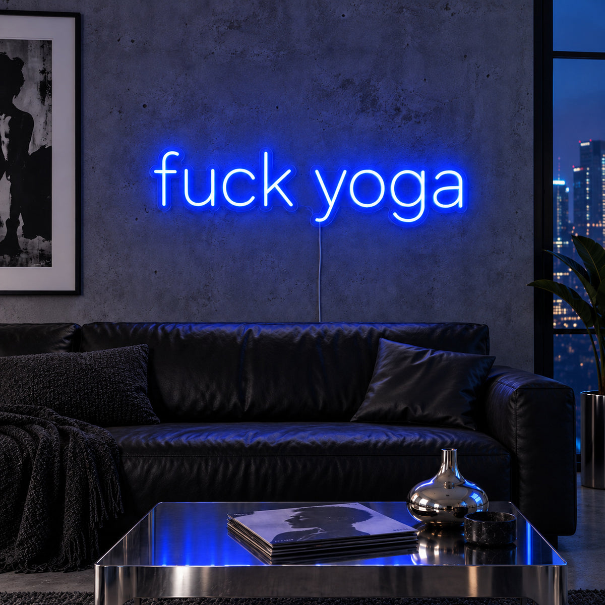 Fuck Yoga Neon Sign glowing blue above a black leather sofa.