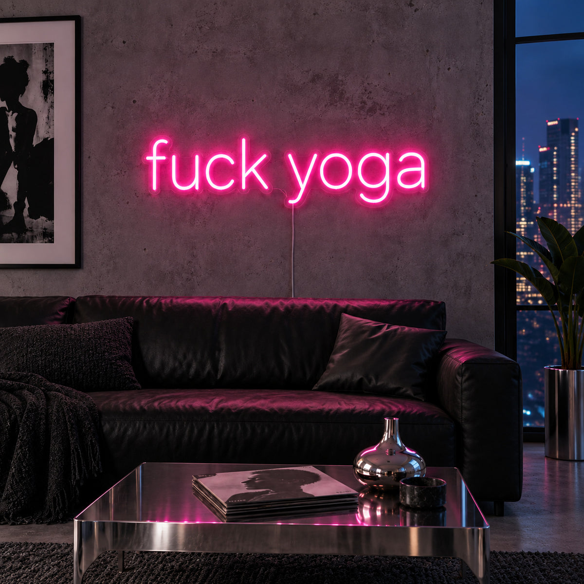Rose Red version of the Fuck Yoga Neon Sign, shown above a black leather sofa.