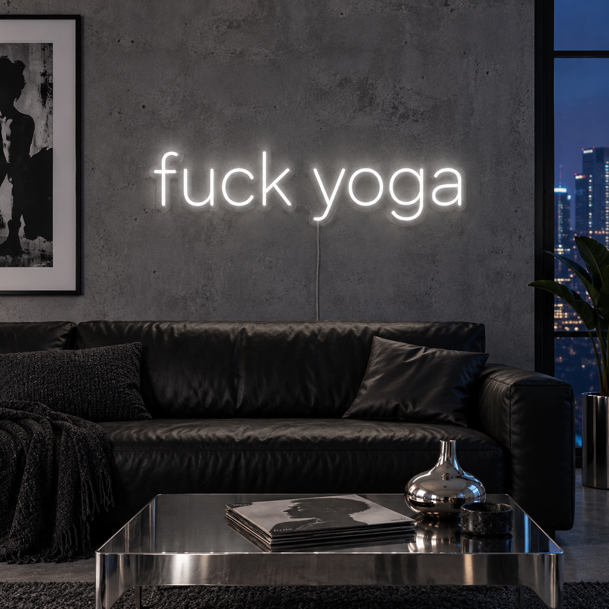 Fuck Yoga Neon Sign in white above a black leather sofa.