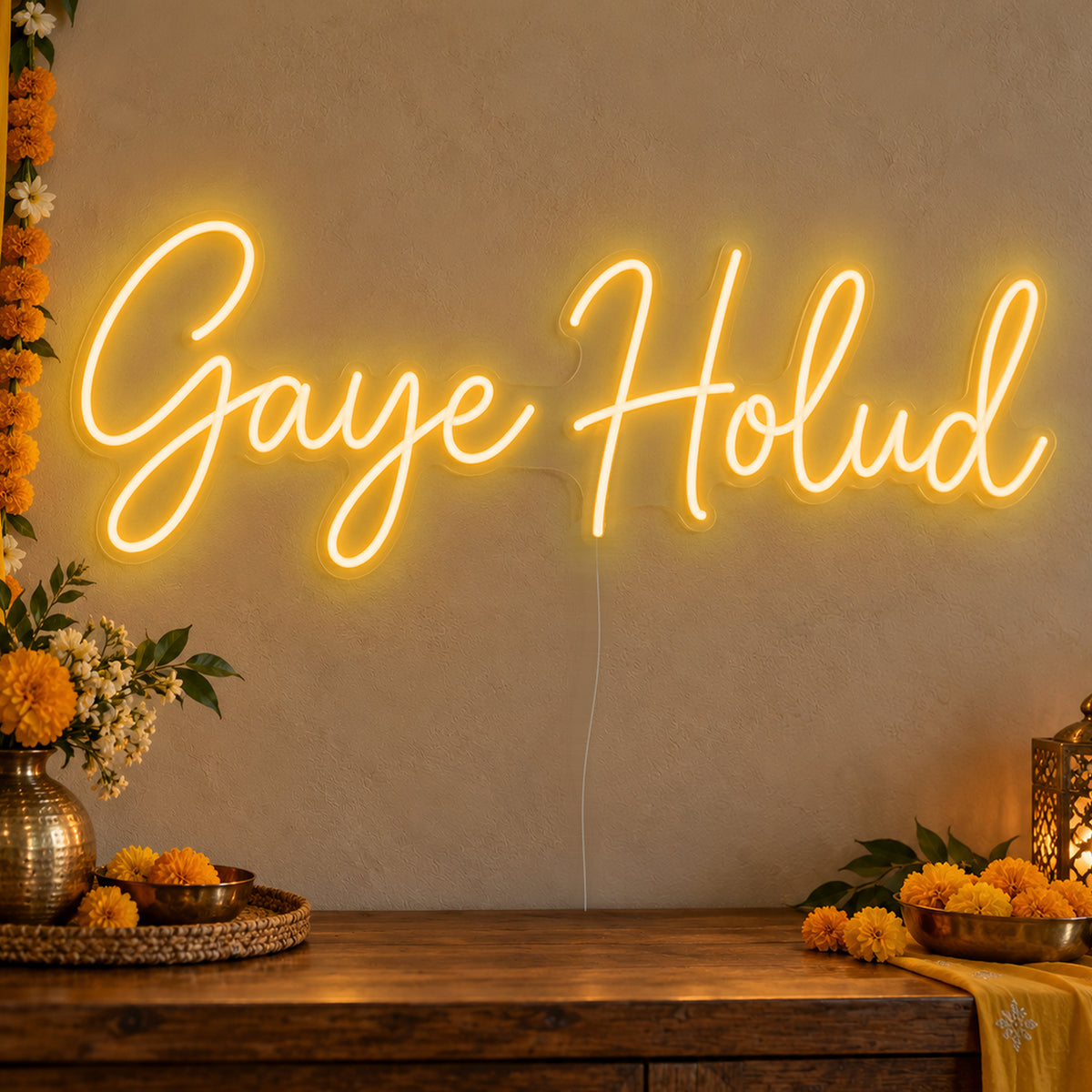 Gaye Holud Neon Sign in gold LED neon on clear acrylic, angled view
