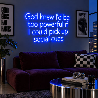 God Knew I'd Be Too Powerful If I Could Pick Up Social Cues Neon Sign glowing blue above a burgundy sofa.