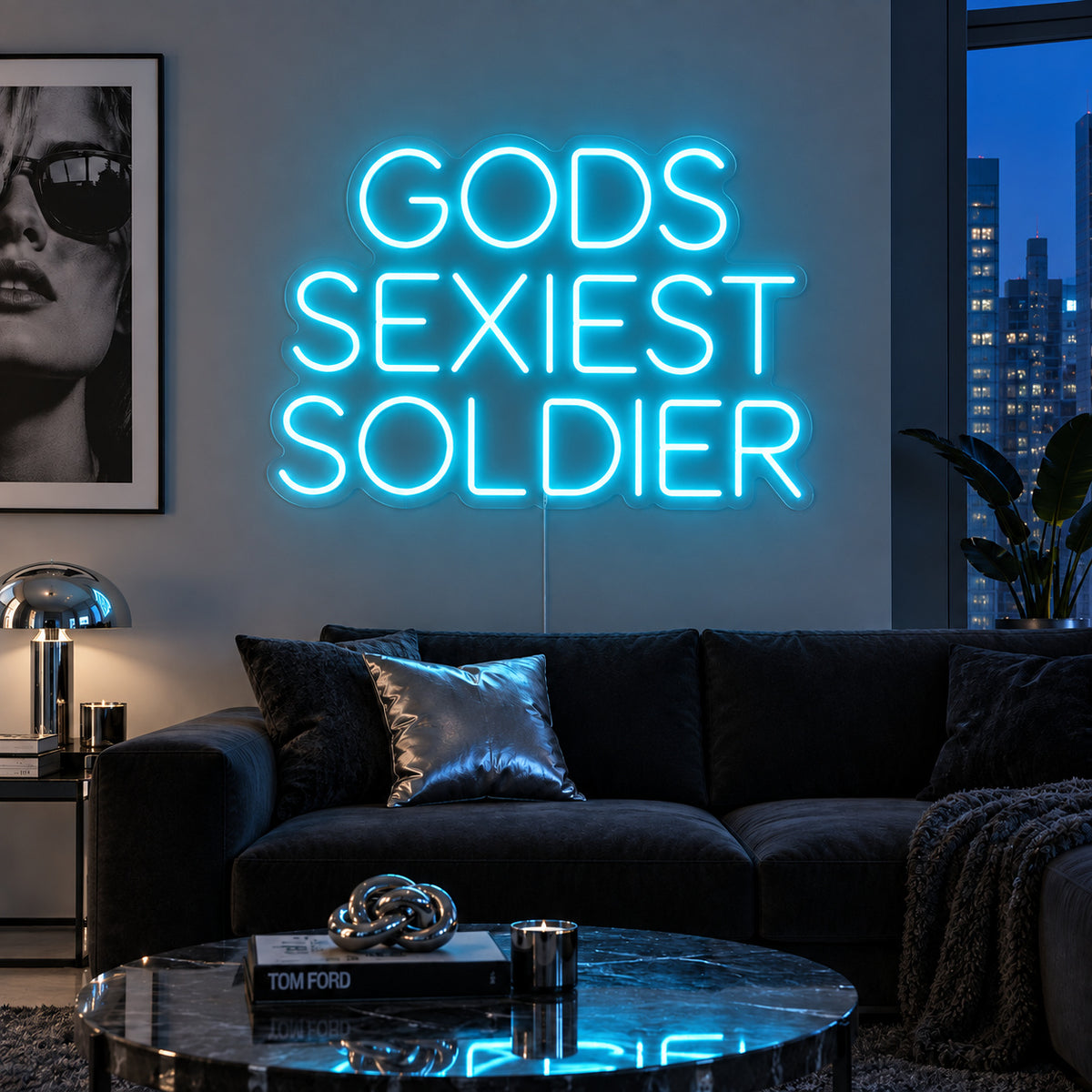 Ice Blue version of the Gods Sexiest Soldier Neon Sign, shown in rounded lettering above a dark sofa.